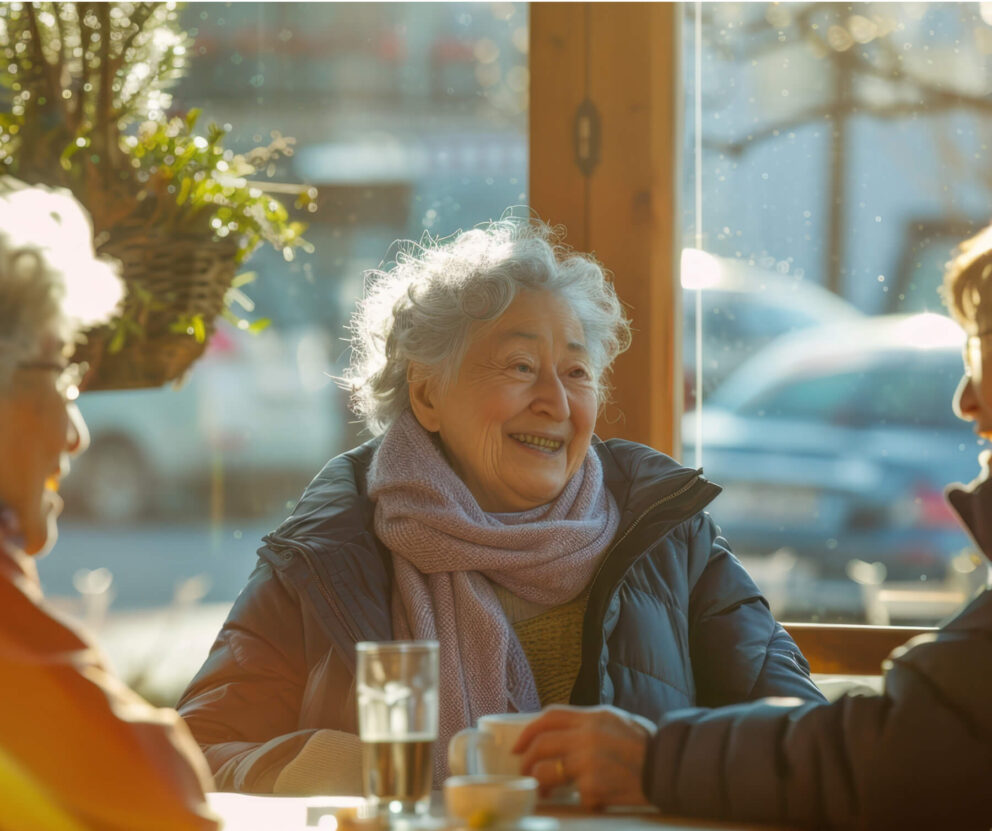 Elderly friends smiling in a cafe