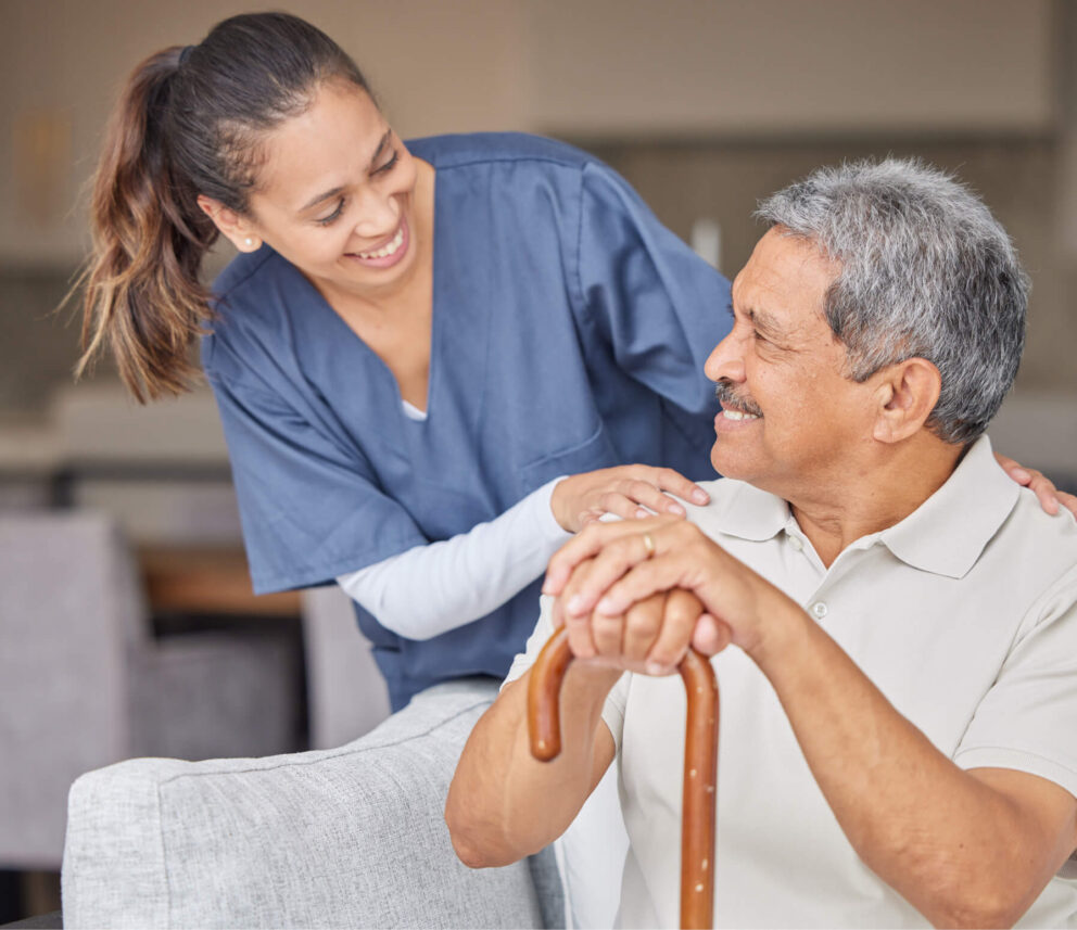 Support worker smiling with elderly man